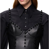 Top donna bustier effetto pelle con sfere decorative